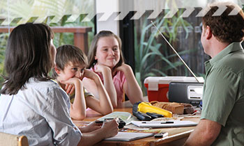 prepare_family.jpg A family sitting down with items from their emergency kit